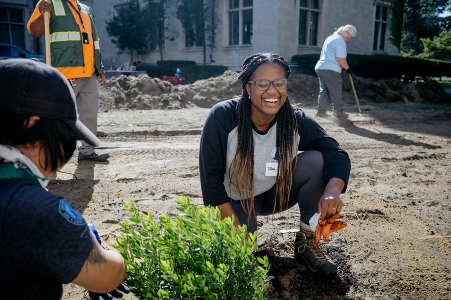 Tiffany Carey Jones planting and laughing with community members at the Marygrove rain garden